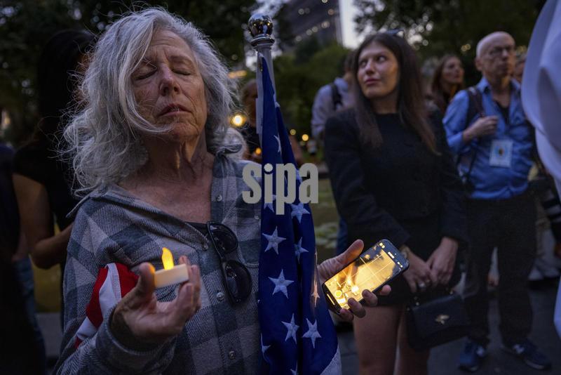 NEW YORK, NEW YORK - SEPTEMBER 12: Members of the New York Young Republicans Club (NYYRC) and dozens of mourners hold a vigil for slain political influencer Charlie in Kirk at the Reflecting Pool in Madison Square Park on September 12, 2025 in New York City. Authorities arrested a suspect, Tyler Robinson, 22, on Friday, ending a two-day manhunt after Mr. Kirk, a conservative activist and Trump ally, was fatally shot during a speaking appearance at Utah Valley University. They believe that Robinson acted alone. (Photo by Michael Nigro/Sipa USA)