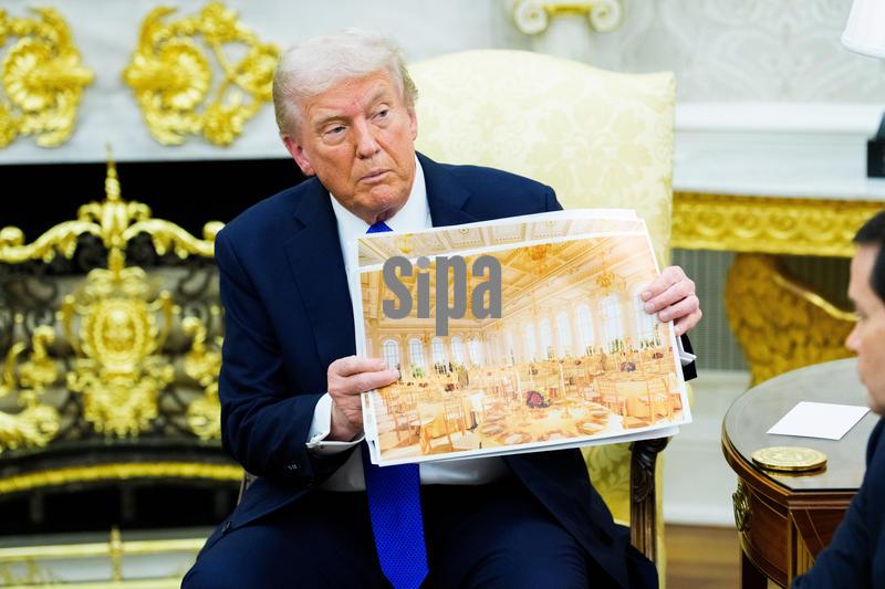 United States President Donald J Trump holds a mockup of the White House ballroom, as he  meets Mark Rutte, Secretary General of the North Atlantic Treaty Organization (NATO) in the Oval Office of the White House in Washington, DC, USA, on Wednesday, October 22, 2025.  The leaders are meeting to discuss continuing support for Ukraine.
Credit: Aaron Schwartz / Pool/Sipa USA