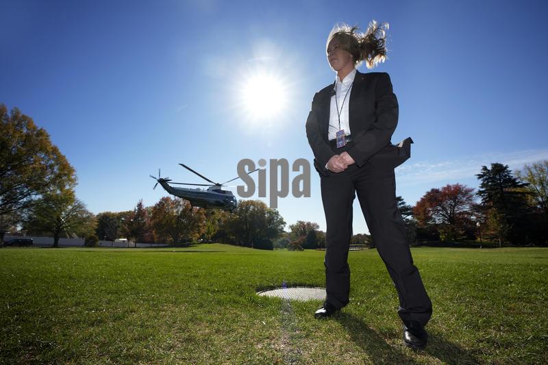 US Secret Service agent stands guard as Marine One helicopter with President Donald Trump on board departs from the South Lawn of the White House in Washington en route to Florida on November 5, 2025. Trump is going to deliver remarks at the America Business Forum in Miami. Photo by Yuri Gripas/Pool/Sipa USA 