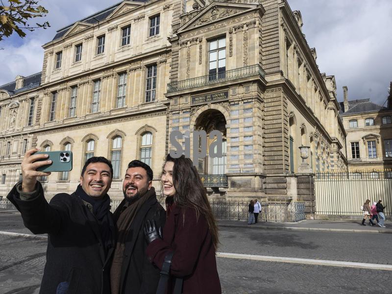 Tourists take photos in front of the balcony of the Galerie Apollon, now known for the jewelry theft that took place there on October 19 at Quai Francois Mitterrand in Paris, France on October 27, 2025. Photo by Axelle de Russe/Abaca/Sipa USA