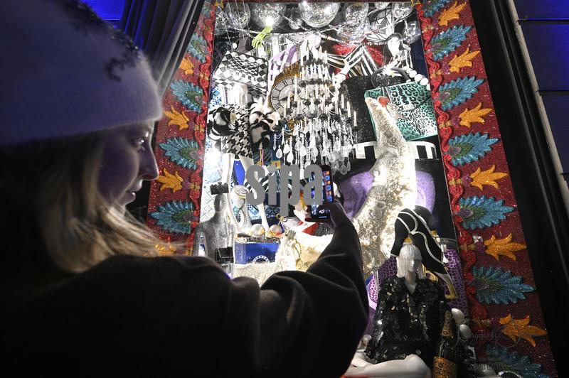 A woman captures newly unveiled Bergdorf Goodman department store holiday window, New York, NY, November 20, 2025. (Photo by Anthony Behar/Sipa USA)