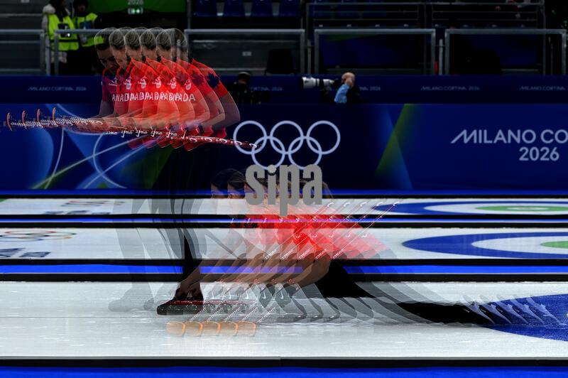An in-camera multiple exposure setting captures Sarah Wilkes of Team  Canada followed by sweeper Emma Miskew during a competition match against Team Italy in the Curling Round Robin Session 11, on day 12 of the Milano Cortina 2026 Winter Olympic Games at the Cortina Curling Olympic Stadium in Cortina d'Ampezzo, Italy, February 18, 2026. (Photo by Anthony Behar/Sipa USA)