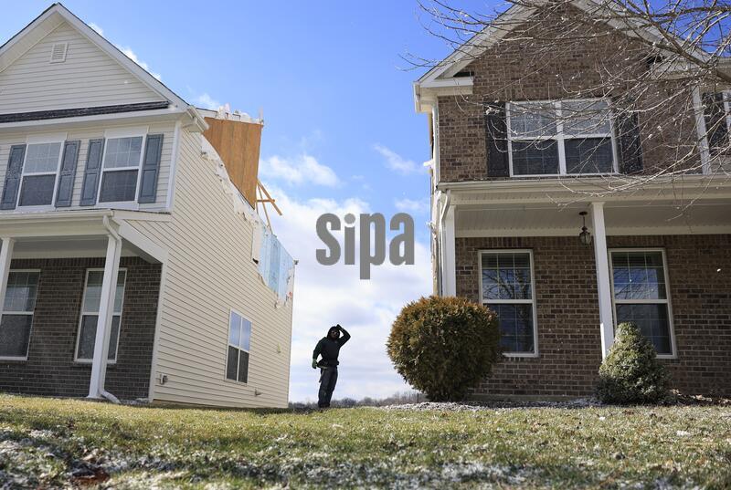 BLOOMINGTON, INDIANA — FEBRUARY 20, 2026: A worker repairs a house in a subdivision after a tornado struck on February 19, 2026, in Bloomington, Indiana. The tornado touched down just after 7 p.m. and was preliminarily rated EF-1. No injuries were reported. (Photo by Jeremy Hogan/Sipa USA)