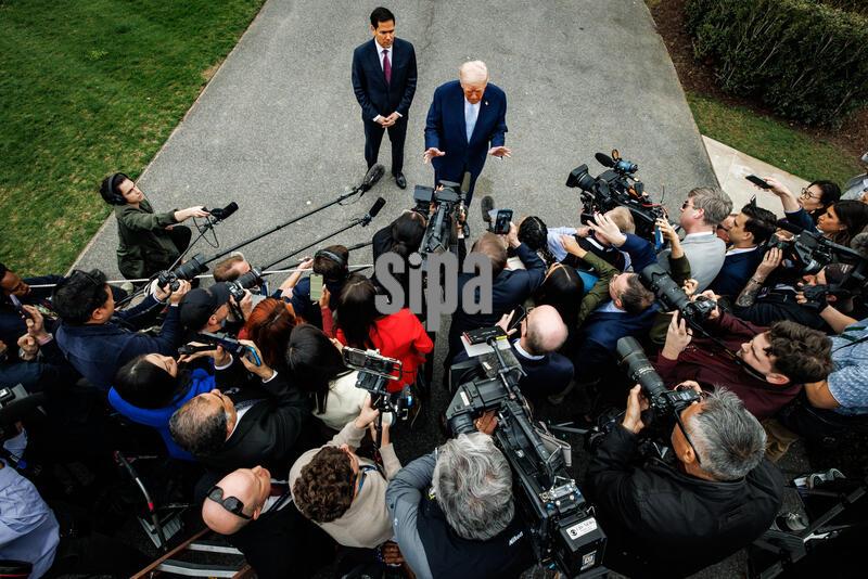 U.S. President Donald Trump speaks to reporters with U.S. Secretary of State Marco Rubio before departing from the South Lawn of the White House in Marine One on March 20, 2026 in Washington, D.C. Trump is heading to Palm Beach, Florida, where he will be spending the weekend at his private club, Mar-a-Lago. (Photo by Samuel Corum/Sipa USA)