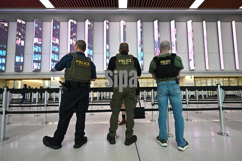 Three ICE Agents stand beside the TSA security screening area inside Delta's Terminal C at LaGuardia, New York, NY, March 23, 2026. ICE agents have been deployed to JFK, Newark (NJ) and LaGuardia airports amid TSA shortages; President trump confirmed Sunday that immigration agents will be sent to airports across the country starting Monday as TSA officers have not been paid and calling out of work as Congress remains stalled over a deal to fund the Department of Homeland Security. (Photo by Anthony Behar/Sipa USA)