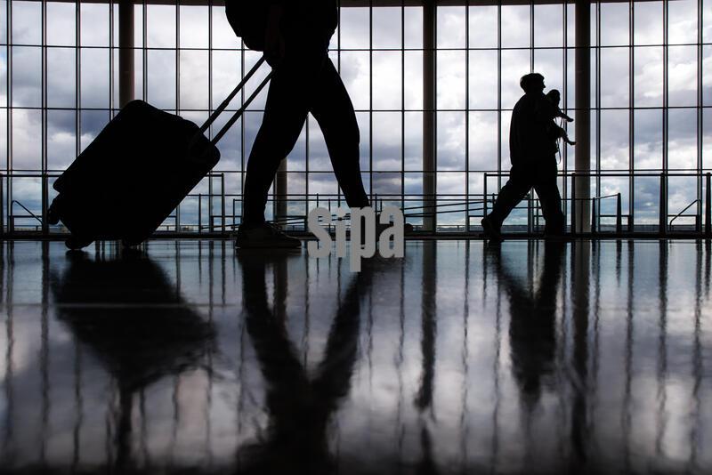 Travelers walk through Ronald Reagan National Airport (DCA) on March 23, 2026 in Arlington, Virginia. Lines at airport security have grown longer and longer ever since Democrats in Congress withheld funding for the Department of Homeland Security forcing TSA agents to work without pay for 37 days without an end in sight. In response, President Trump has order that Immigration, Customs, and Enforcement (ICE) agents would be deployed to assist the TSA at airports around the United States. (Photo by Samuel Corum/Sipa USA)