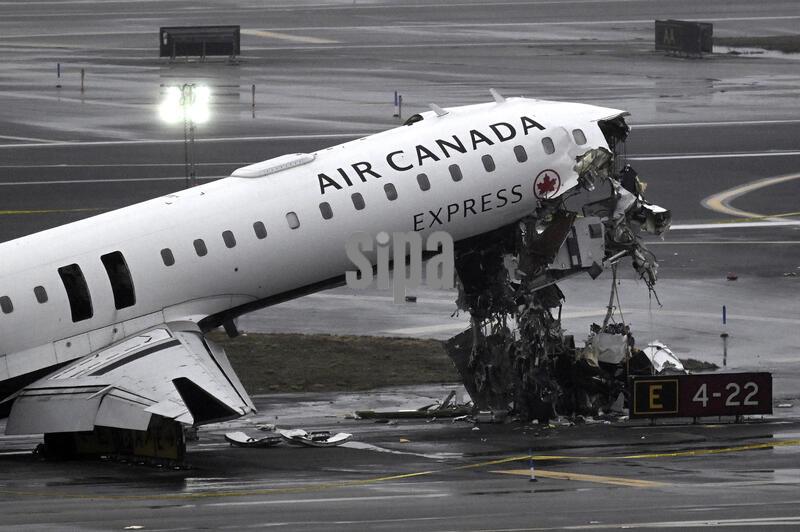 The wreckage from the collision between an Air Canada plane and a fire truck is seen on the runway at LaGuardia Airport in Queens, New York on March 23, 2026. LaGuardia Airport in Queens, New York was closed for part of the day on Monday March 23, 2026 after an Air Canada plane collided with a fire truck leaving the pilot and co-pilot dead and injuring passengers. (Photo by Anthony Behar/Sipa USA)