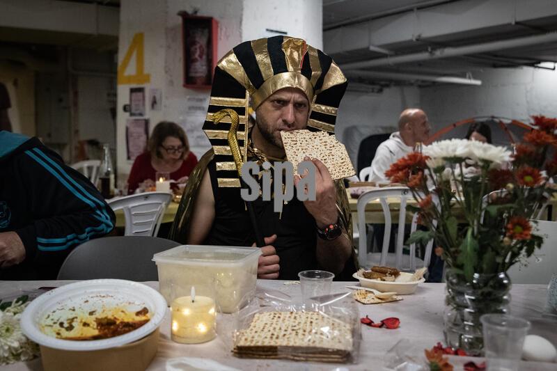 (260402) -- TEL AVIV, April 2, 2026 (Xinhua) -- A man eats Matzo, or unleavened bread, during a Passover Seder at an underground shelter in Tel Aviv, Israel, April 1, 2026. The week-long Jewish holiday of Passover began at sunset on April 1 and will end at sunset on April 8. As the military conflict continues, some Israelis chose to observe the traditional holiday meal in protective facilities. (Xinhua/Chen Junqing) (Photo by Xinhua/Sipa USA)