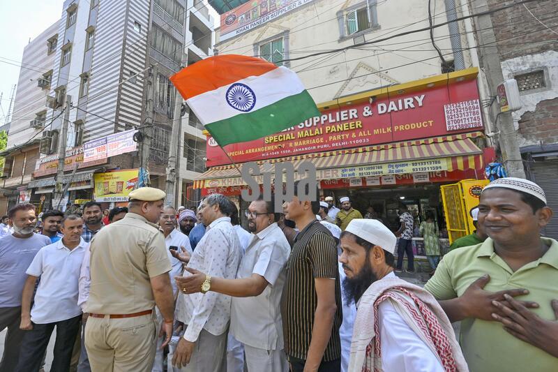 India: Members Of The Muslim Community Welcome Hindu Devotees During Hanuman Jayanti Procession At Jahangirpuri In New Delhi