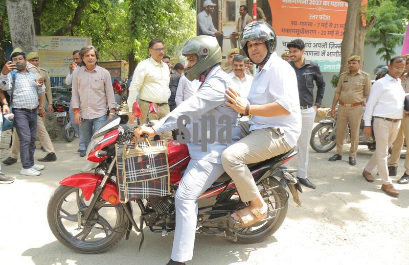 India: Ghaziabad DM Ravindra Kumar Mandar Commutes Pillion Rider On A Motorcycle To His Office