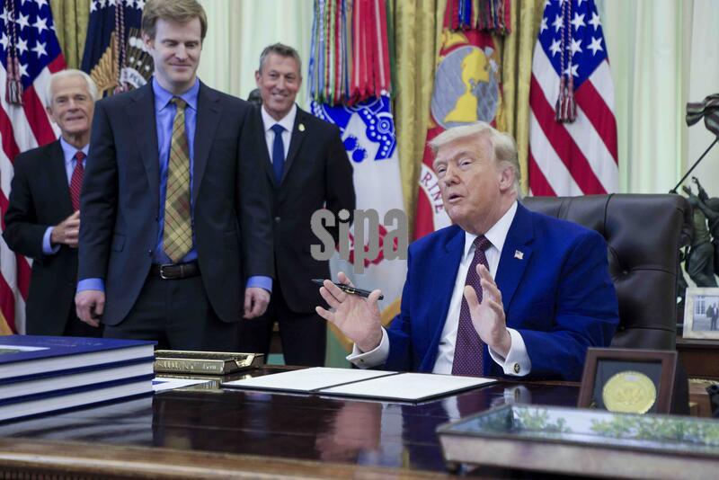 US President Donald J. Trump takes questions from the news media during an executive order signing ceremony