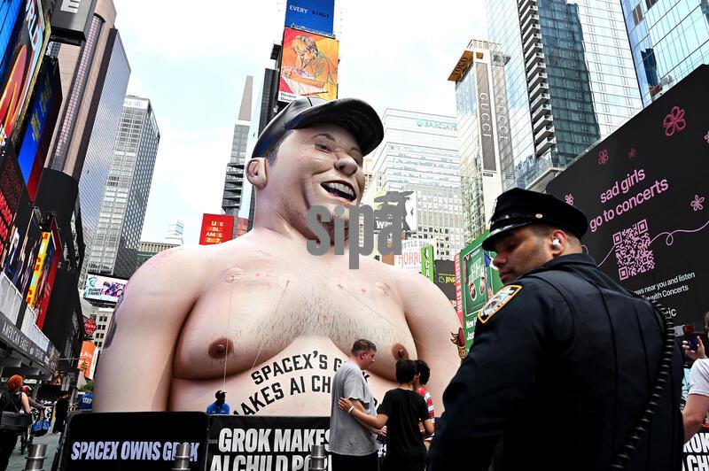 A 40ft inflatable effigy of Elon Musk is seen in Times Square ahead of SpaceX's scheduled June 12 Nasdaq IPO, New York, NY, June 11, 2026. The group that set up the large effigy on Father Duffy Square is protesting 'Grok' a generative AI chatbot that is part of Musk's xAI.  (Photo by Anthony Behar/Sipa USA)