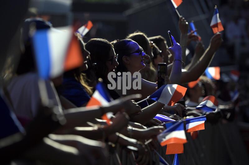 People wave French flags as they attend concerts in Central Park during a Bastille Day celebration sponsored by the Consulate General of France in New York, Sunday, July 12, 2026, in New York. (Photo by Anthony Behar/SipaUSA) 