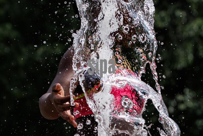 A girl plays in the M Street Water Park in the summer heat on July 20, 2026 in Washington, D.C. The past few weeks have seen temperatures reach well into the 90’s with the heat index rising above 110 degrees on some days in the Washington region. (Photo by Samuel Corum/Sipa USA)