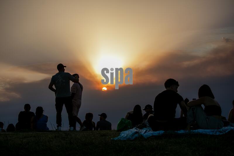 People watch the sunset through the smoke at a viewpoint in Madrid
A thick plume of smoke has blanketed the city of Madrid for much of the day, the result of several wildfires burning in the outskirts of the Spanish capital. (Photo by David Canales / SOPA Images/Sipa USA)