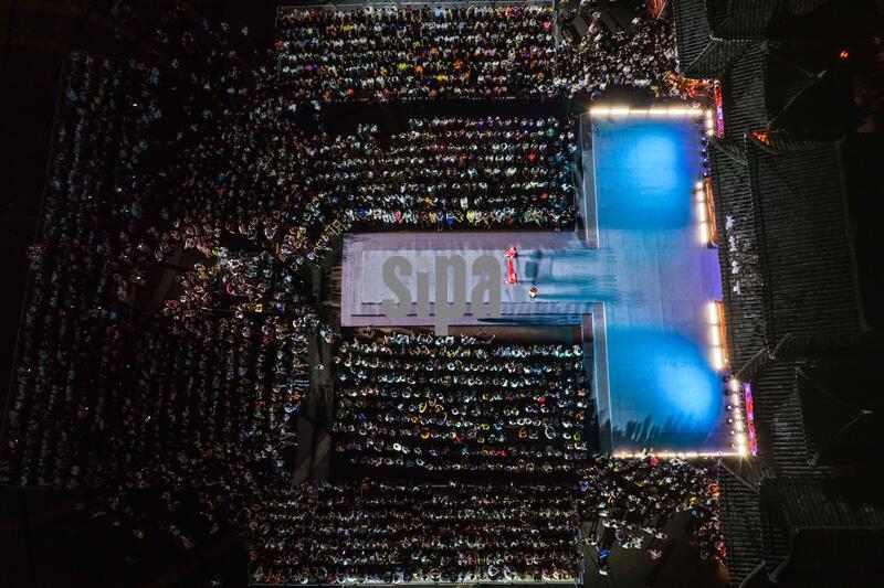 (260724) -- KAILI, July 24, 2026 (Xinhua) -- An aerial drone photo taken on July 23, 2026 shows the venue of the "Village T" fashion show in Kaili, Qiandongnan Miao and Dong Autonomous Prefecture, southwest China's Guizhou Province. A celebration event marking the second anniversary of the "Village T" fashion show was held here on Thursday. Teams from across China came to showcase the beauty of ethnic costumes and the charm of intangible cultural heritage, attracting large numbers of visitors. (Xinhua/Yang Wenbin) (Photo by Xinhua/Sipa USA)