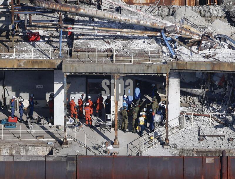 Photo taken from a Kyodo News helicopter shows search and rescue operations continuing for a missing person at a partially destroyed Nippon Paper Industries Co. plant in Yatsushiro, Kumamoto Prefecture, on July 30, 2026, two days after a powerful earthquake hit the southwestern Japan prefecture.  (Photo by Kyodo News/Sipa USA)
