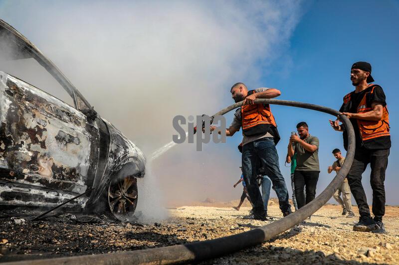 (260814) -- GAZA, Aug. 14, 2026 (Xinhua) -- Palestinian firefighters try to extinguish a fire that broke out in a vehicle carrying Gaza Police Chief Jamal Mahmoud Abu Kamil after it was targeted by an Israeli airstrike on Rashid Street, southwest of Gaza City, on Aug. 13, 2026. The Hamas-run interior authorities in the Gaza Strip said on Thursday that the 43-year-old Gaza Police Chief Jamal Mahmoud Abu Kamil was killed in an Israeli airstrike that targeted his vehicle on Rashid Street, southwest of Gaza City. (Photo by Rizek Abdeljawad/Xinhua) (Photo by Xinhua/Sipa USA)