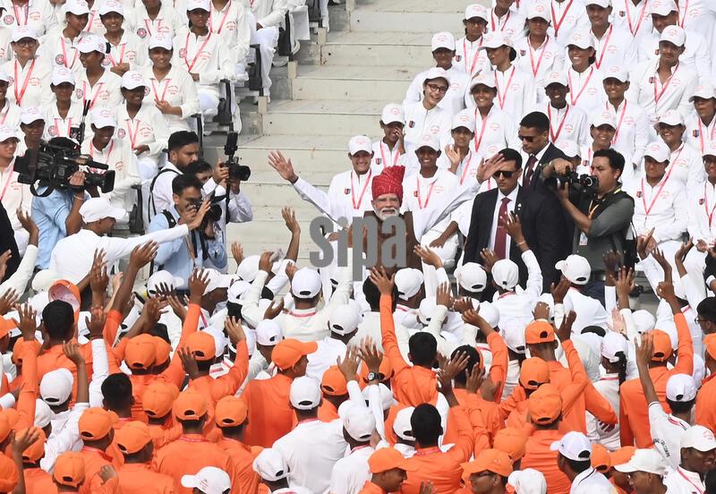 NEW DELHI, INDIA - AUGUST 15: Prime Minister Narendra Modi greets school children and National Cadet Corps (NCC) cadets after delivering a speech from the Red Fort during Independence Day celebrations on August 15, 2026 in New Delhi, India. For the first time, the national song, 'Vande Mataram', was rendered during the celebrations at the Red Fort. The National Anthem rendition was synchronised with the 21-gun salute by the gunners of the 1721 Field Battery (Ceremonial), utilising the indigenous 105mm Light Field Guns. PM Modi announced a nationwide initiative to provide free online coaching for competitive exams during his Independence Day address on August 15, 2026. The scheme aims to leverage India's digital infrastructure and top educators to ease the heavy financial burden private coaching hubs place on poor and middle-class families. (Photo by Sonu Mehta/Hindustan Times/Sipa USA )