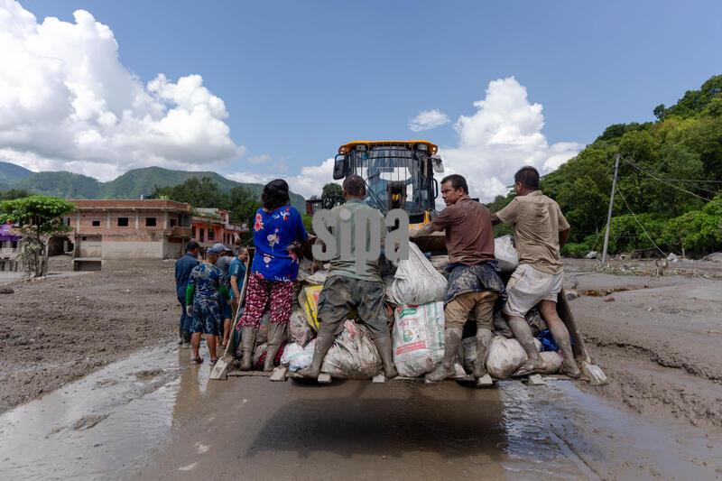 (260827) -- NUWAKOT, Aug. 27, 2026 (Xinhua) -- A vehicle transfers people after a massive flash flood in Nuwakot, Nepal, on Aug. 27, 2026. Nepal's National Disaster Risk Reduction Management Authority said that as many as 359 bodies had been recovered from flood-hit areas by Thursday evening, with 910 people still missing. (Photo by Sulav Shrestha/Xinhua) (Photo by Xinhua/Sipa USA)