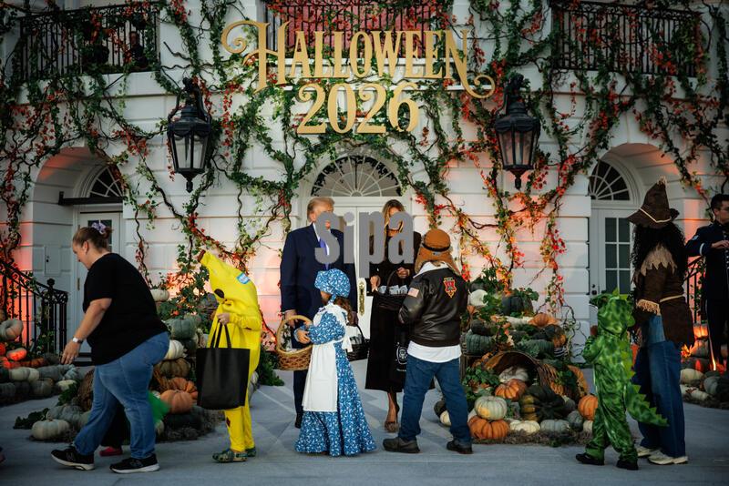 President Donald Trump and First Lady Melania Trump hand out candy to children in costume during a Halloween event on the South Lawn of the White House on October 29, 2026 in Washington, D.C. The President and First Lady welcomed military, law enforcement, administration officials and their children to the annual trick-or-treat celebration on the White House grounds. (Photo by Samuel Corum/Sipa USA)