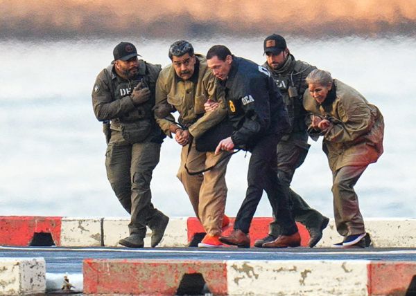Venezuelan President Nicolas Maduro and his wife, Cilia Flores, are seen in handcuffs after landing at a Manhattan helipad, escorted by heavily armed Federal agents as they make their way into an armored car en route to a Federal courthouse in Manhattan on January 5, 2026 in New York City.